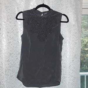 Sleeveless blouse with beaded applique